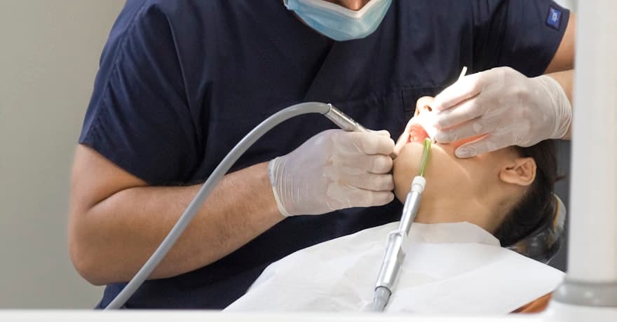 A dentist treating a patient in the chair