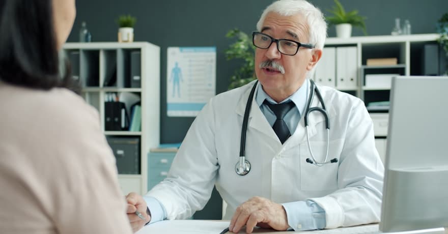 A doctor talking a patient through their consultation
