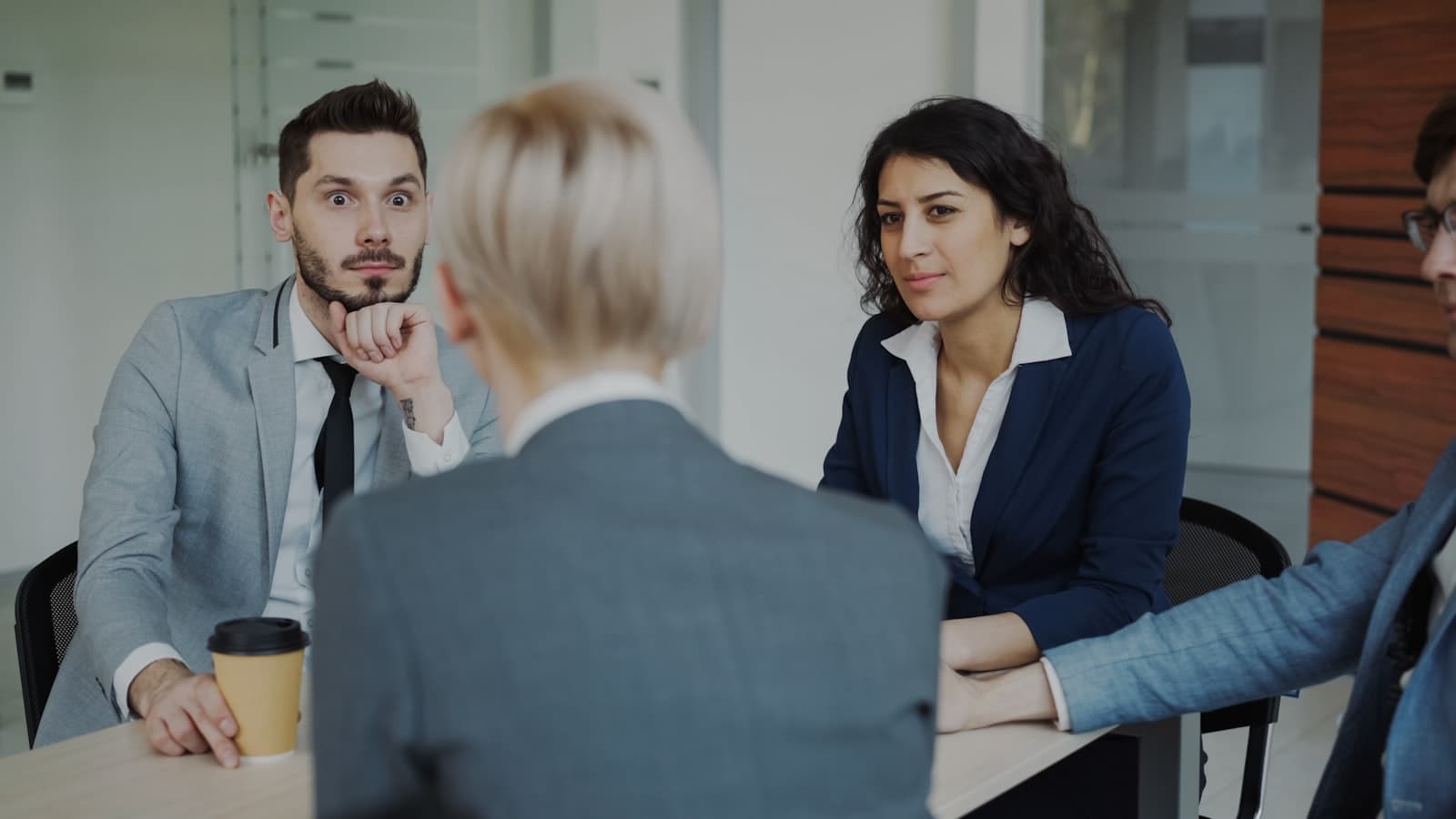 Two colleagues discussing a client opportunity across a meeting table